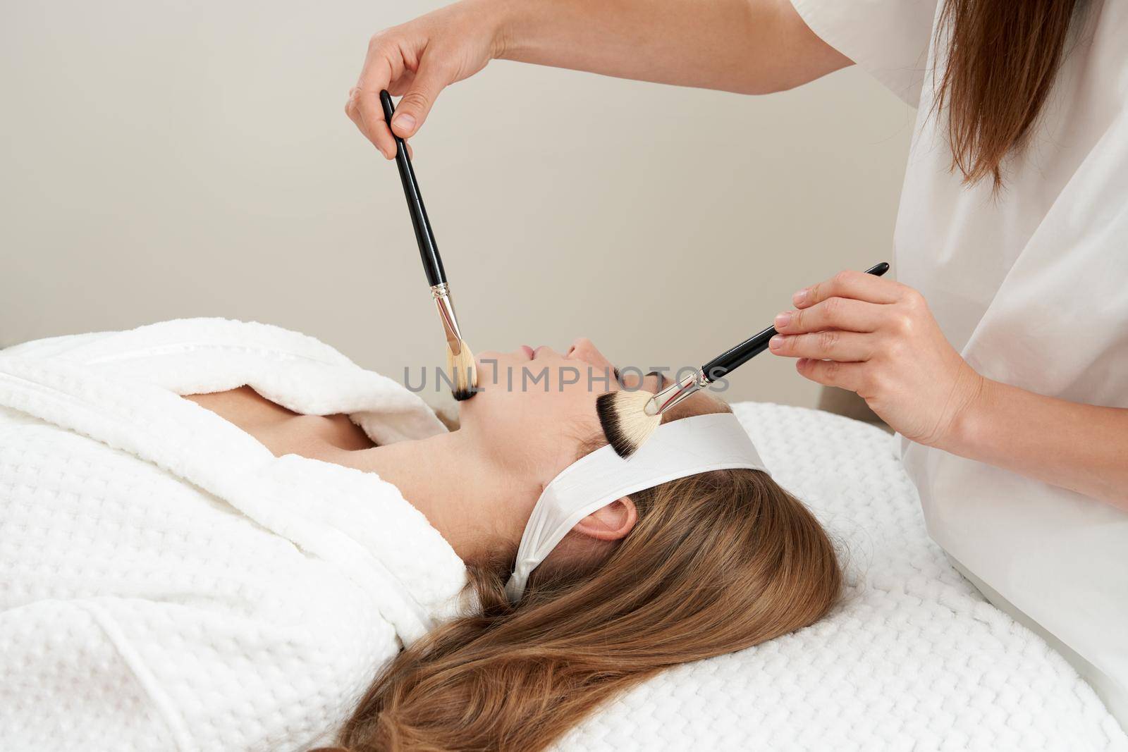 Face Skin Care. Woman Gets Brushes Treatment At Beauty Clinic