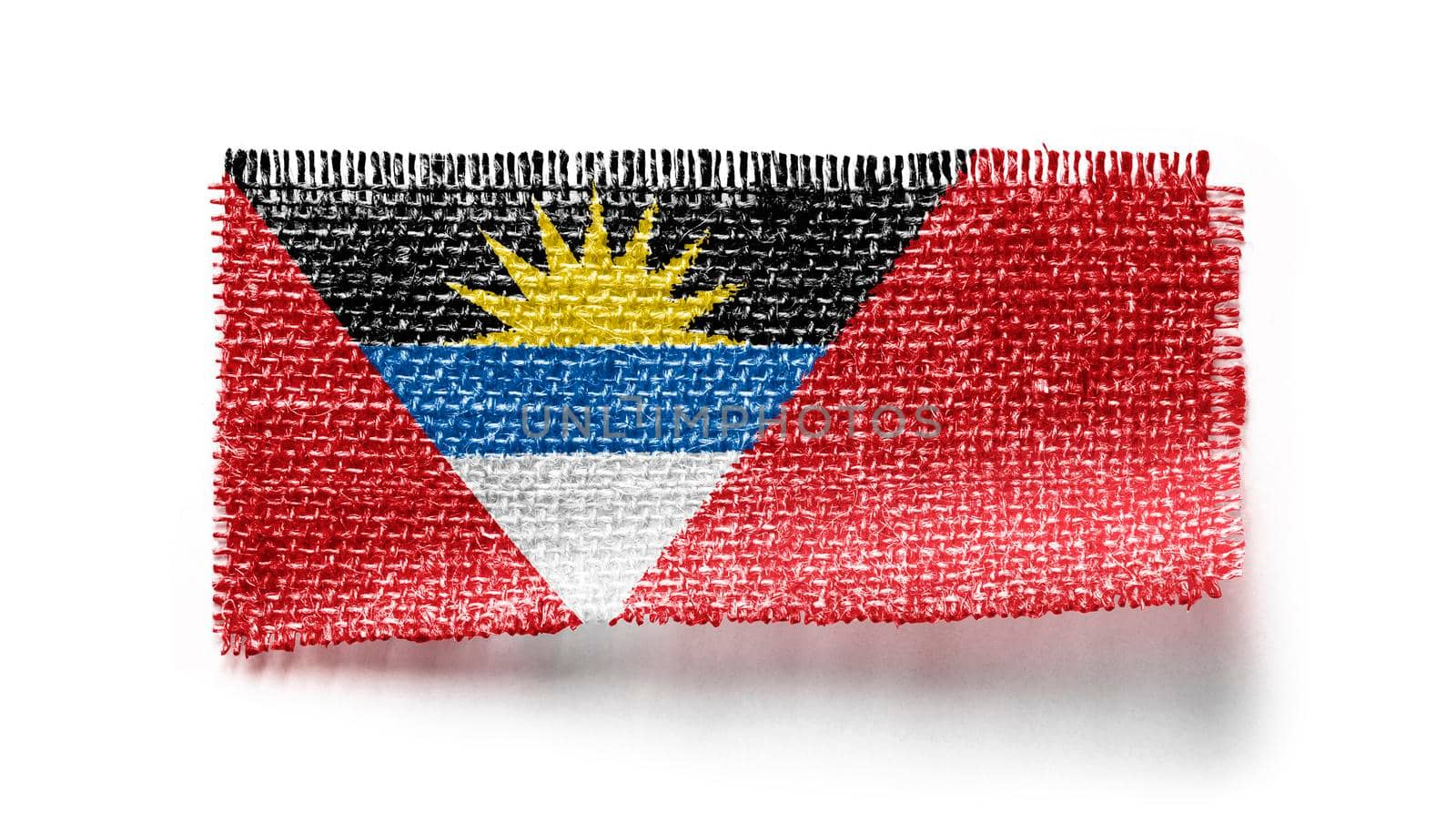 Antigua and Barbuda flag on a piece of cloth on a white background.