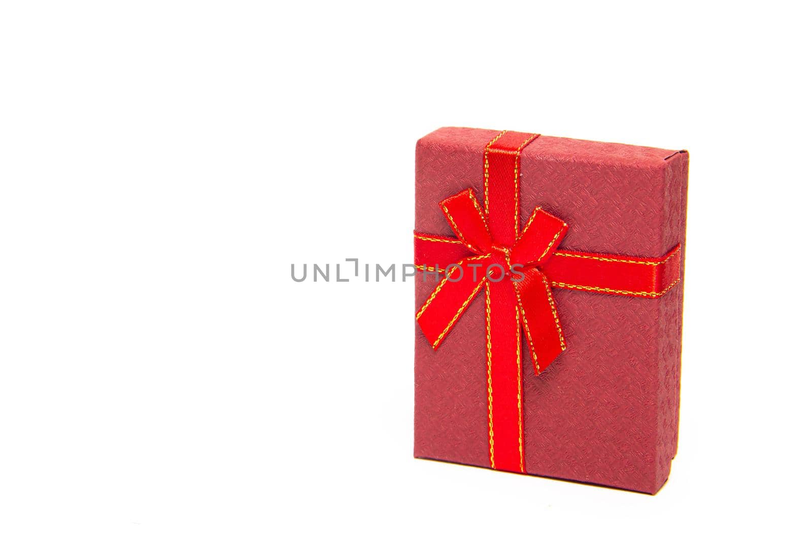 The gift box is red on a white background . New Year and Christmas, birthday. Gift. White background. Copy Space