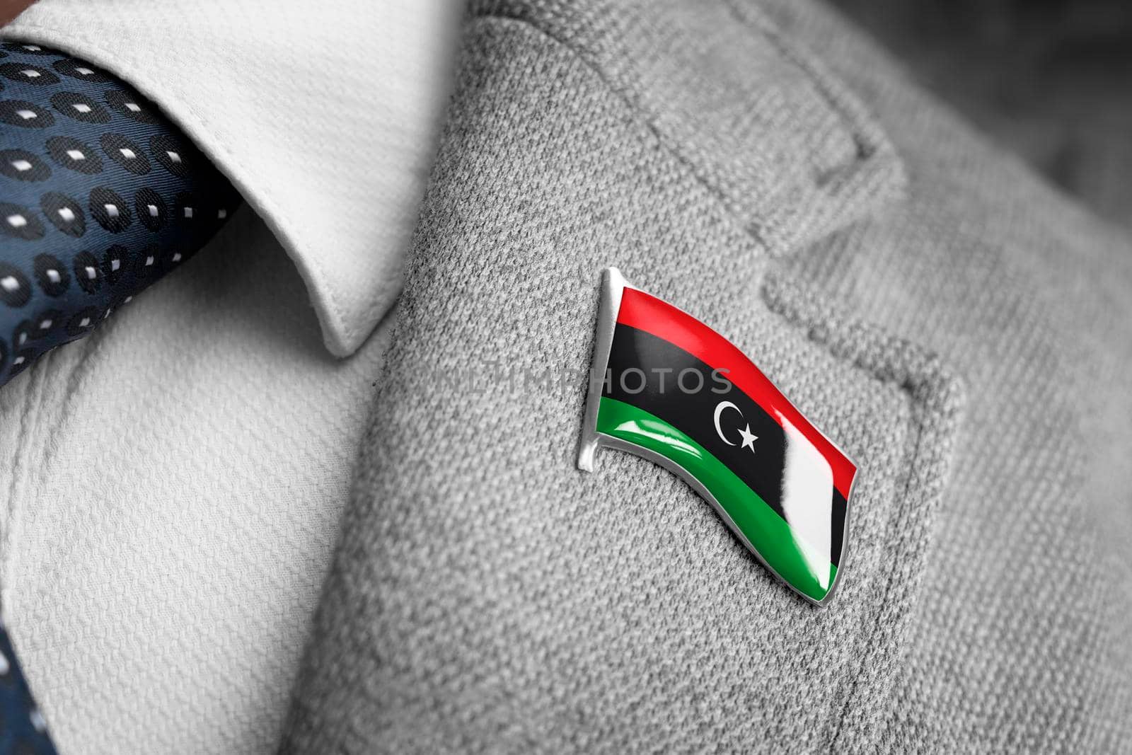 Metal badge with the flag of Libya on a suit lapel.