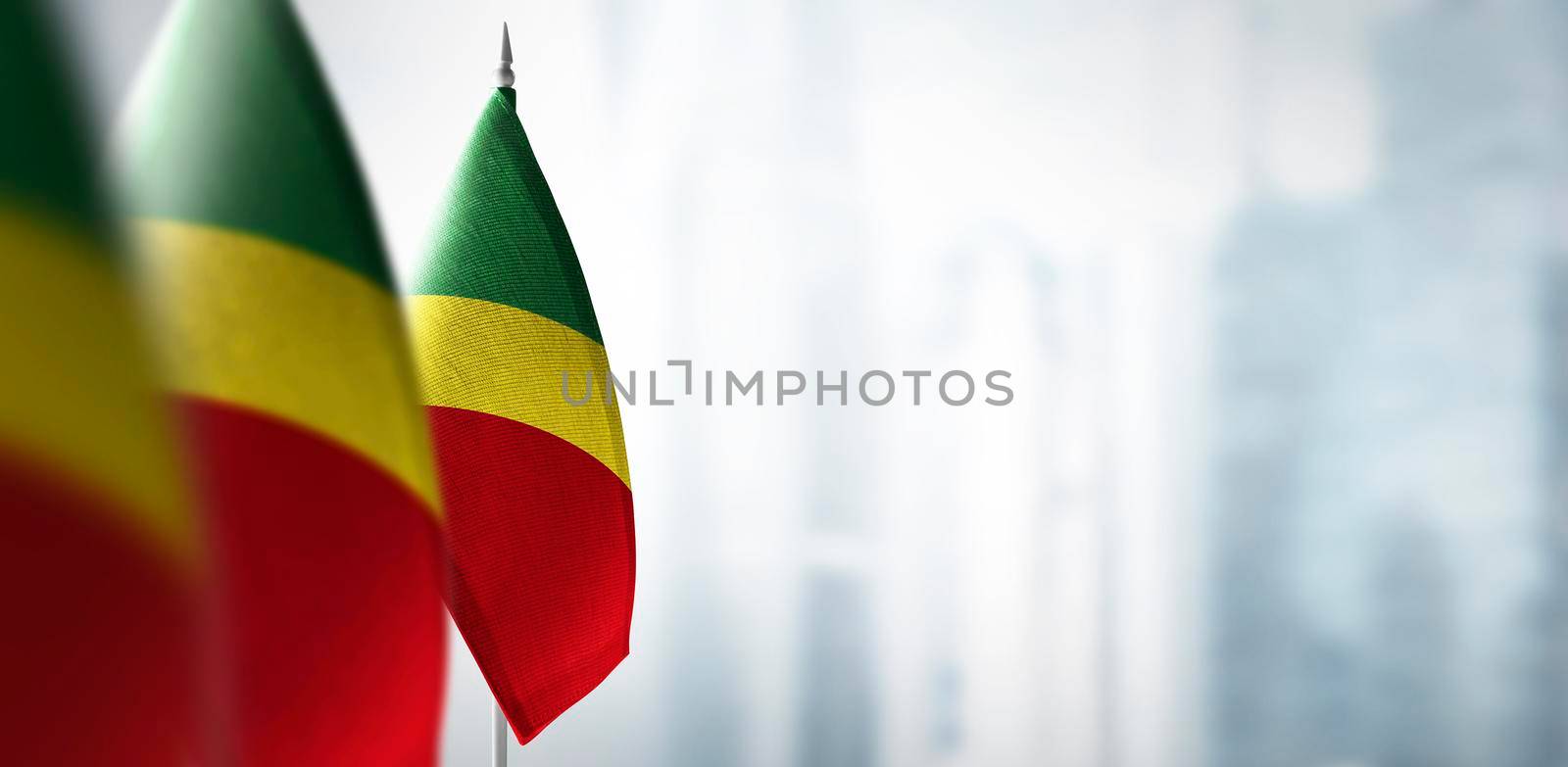 Small flags of Congo on a blurry background of the city by butenkow