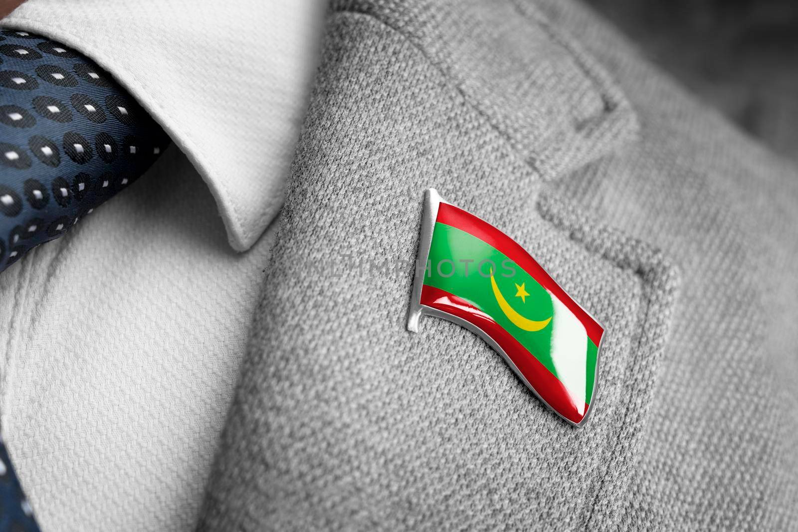 Metal badge with the flag of Mauritania on a suit lapel.