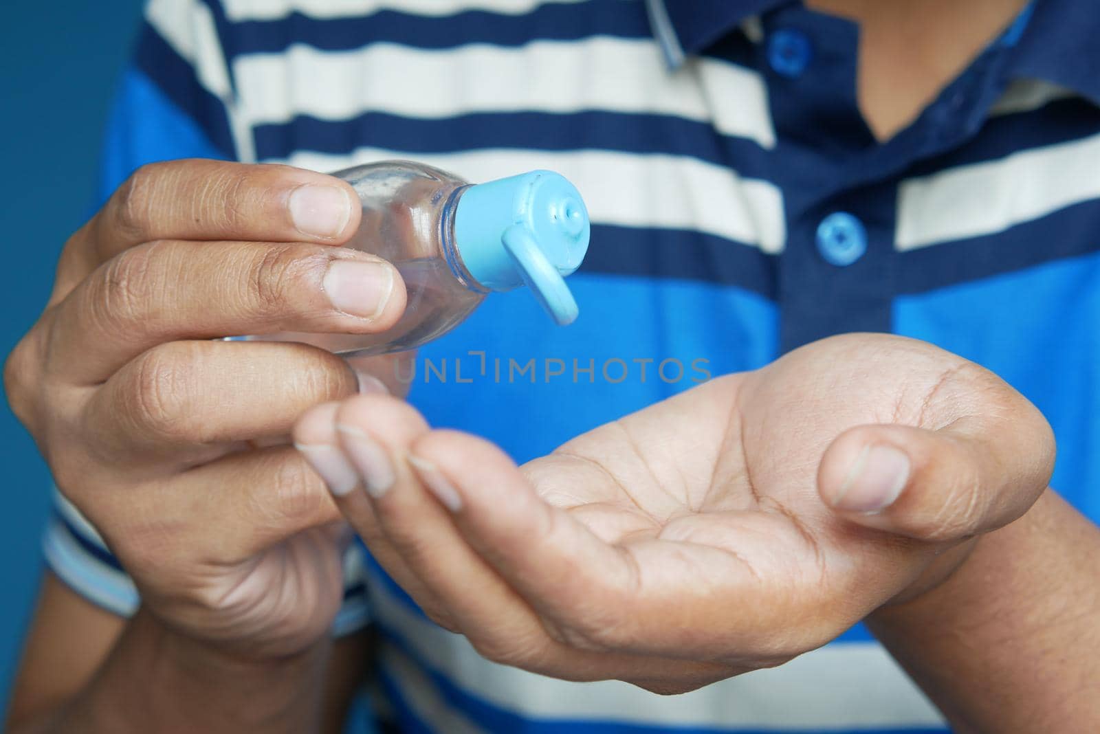 close up of young man hand using sanitizer gel for preventing virus.