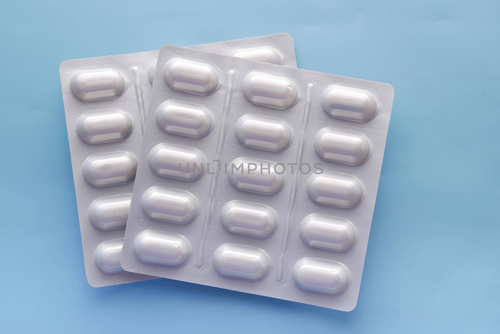 Close up of pills of blister pack on table by towfiq007