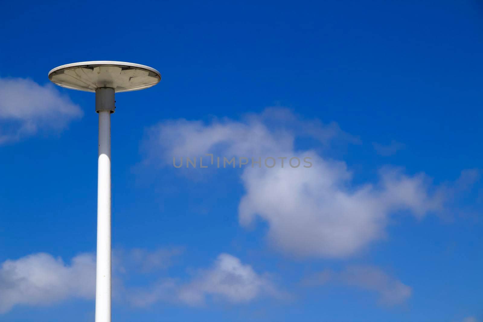 White lamppost in the morning under blue sky in Spain
