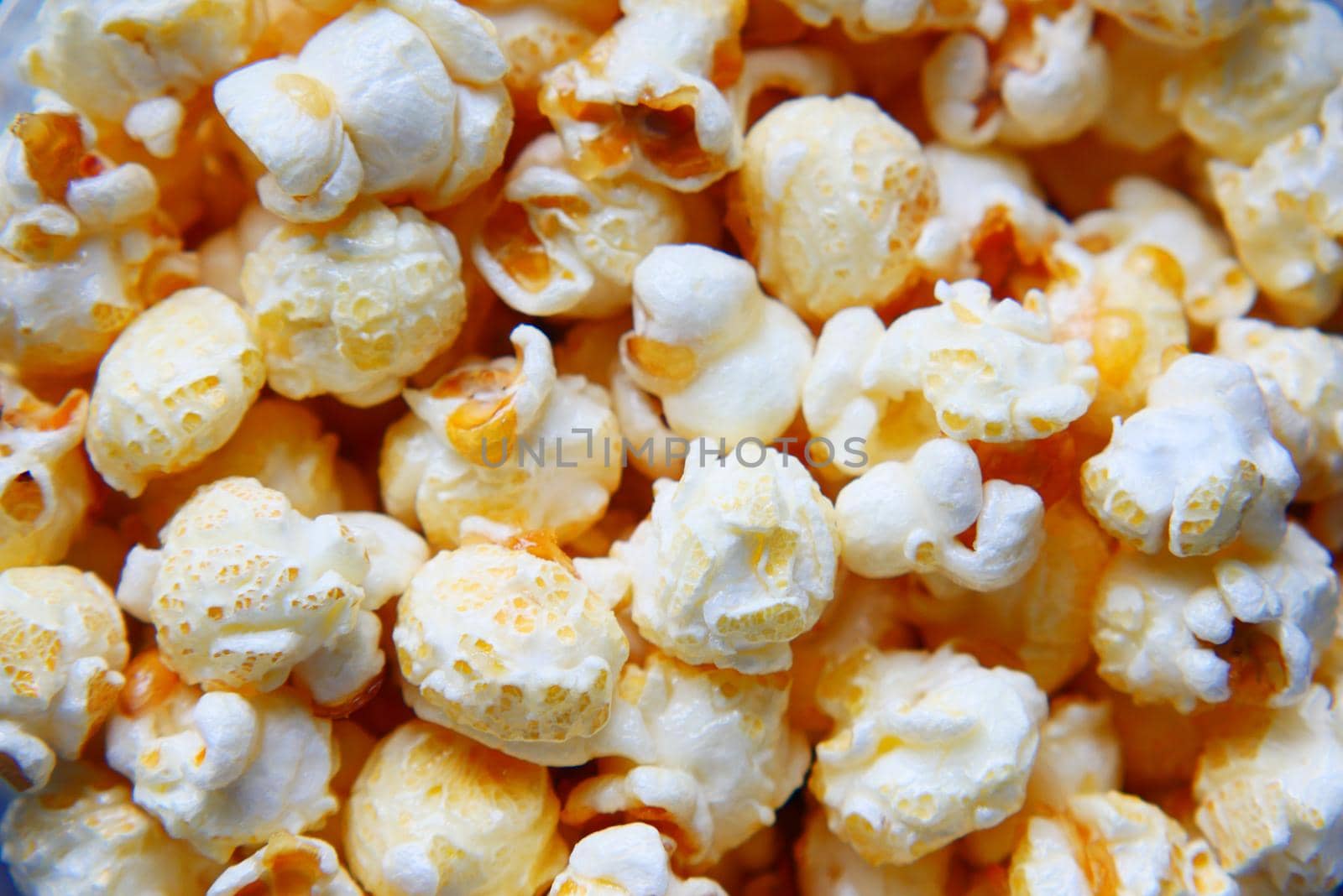 detail shot of popcorn in a bowl on wooden desk by towfiq007