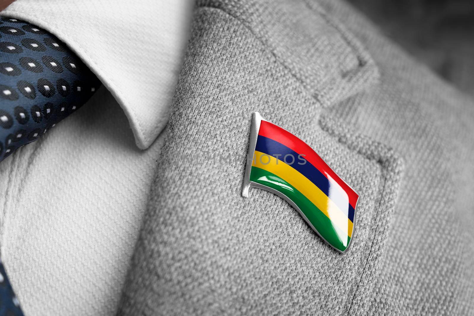 Metal badge with the flag of Mauritius on a suit lapel.