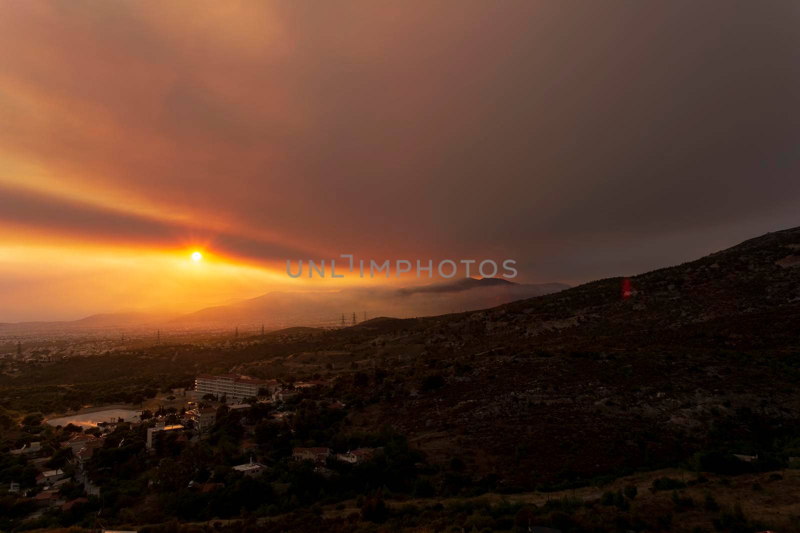 Athens view at sunset with red and yellow clouds from Penteli mountain. by ankarb