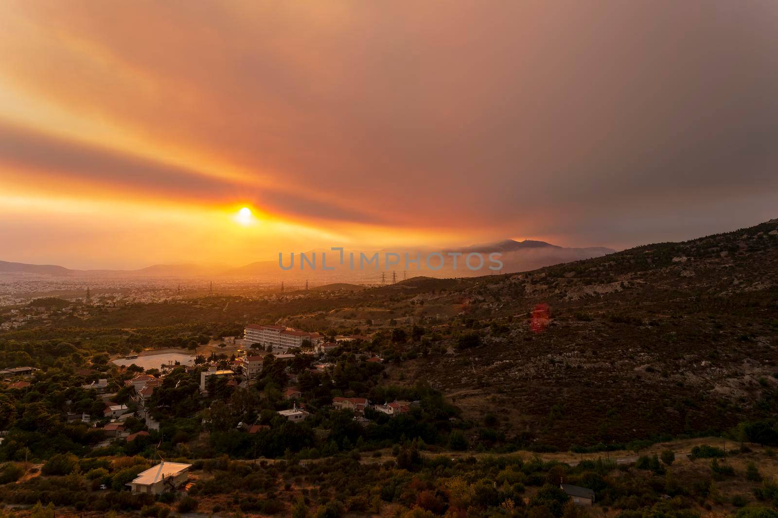 Athens view at sunset with red and yellow clouds from Penteli mountain. Greece.