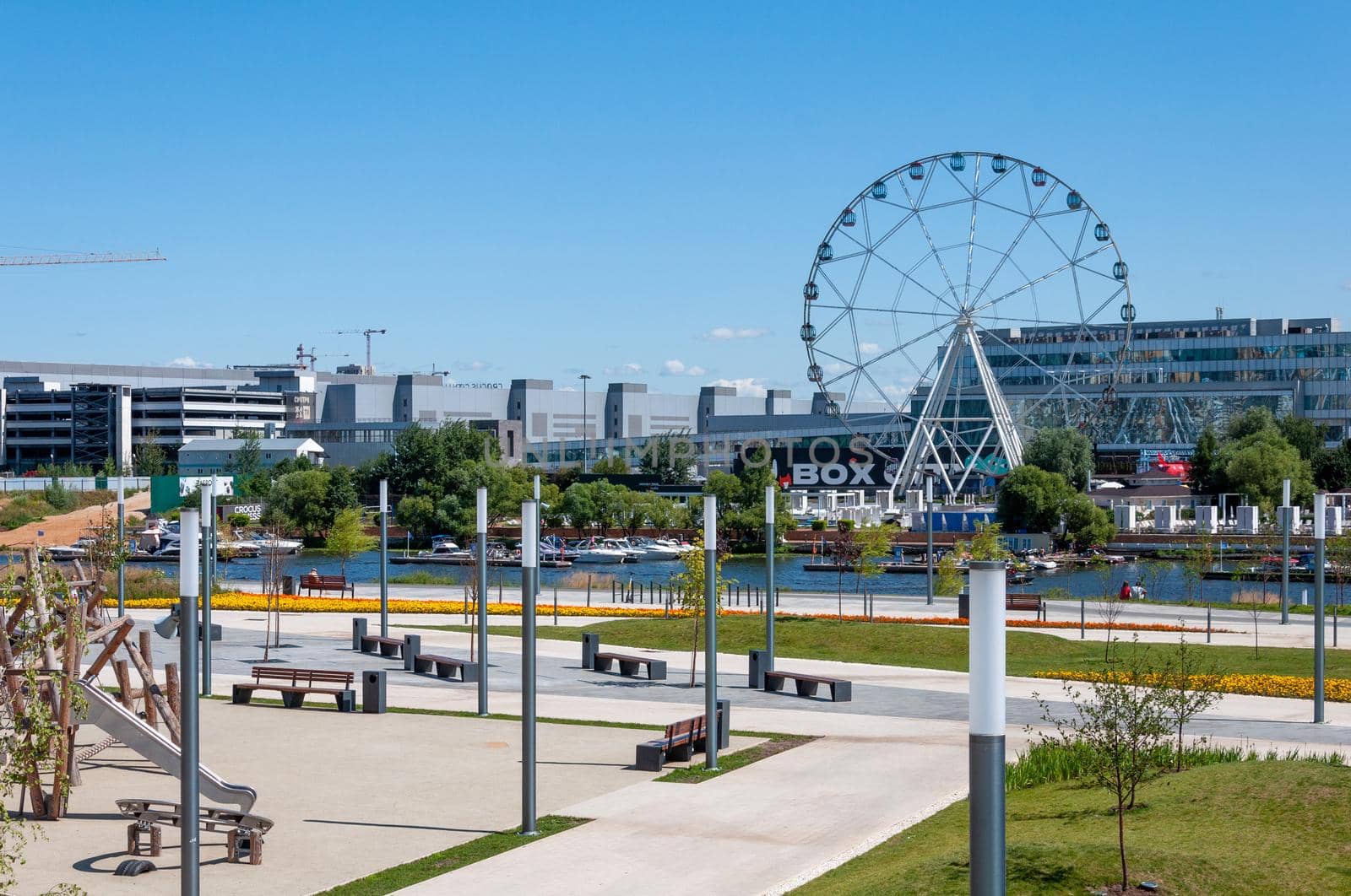 Krasnogorsk, Russia - July 22. 2021. View of embankment and a ferris wheel