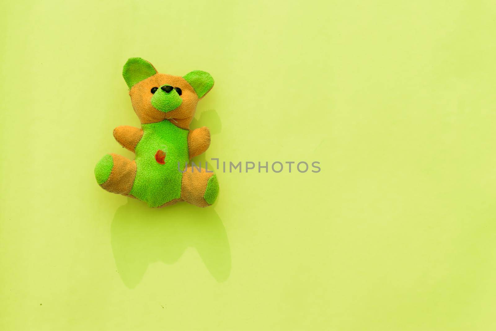 Rabbit teddy bear on yellow color background. Table top view. Flat lay. Copy space for text. by sudiptabhowmick