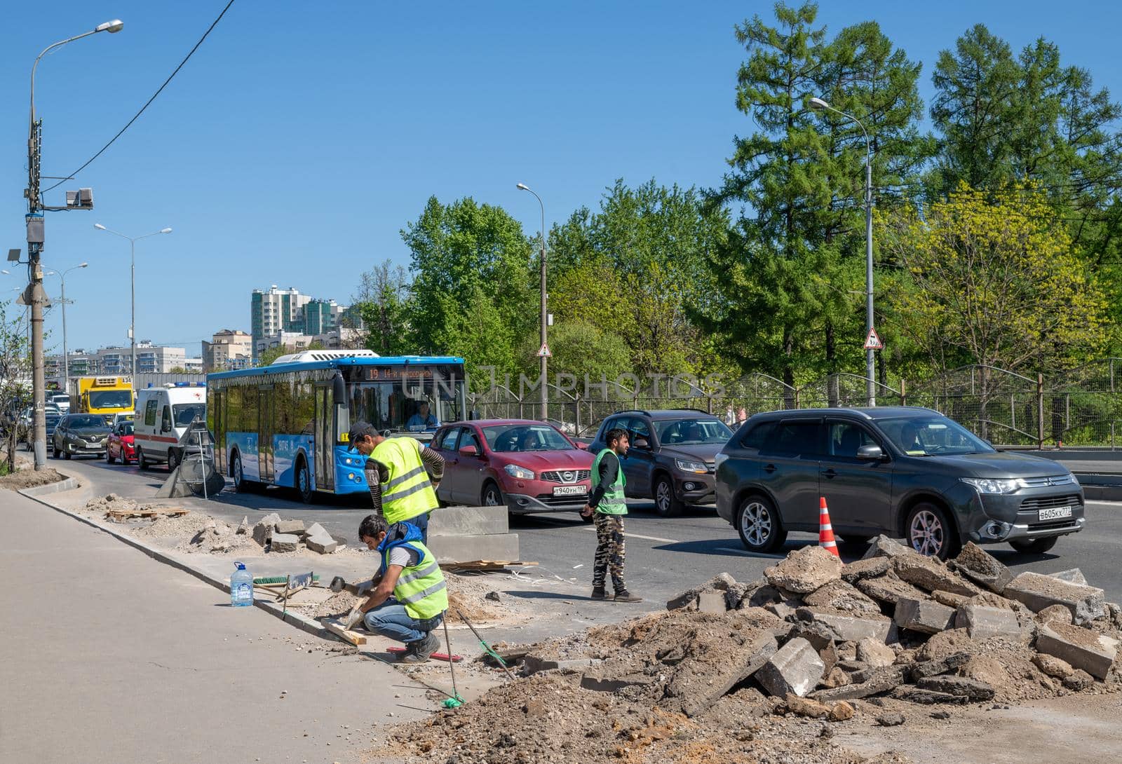 Moscow, Russia - May 9. 2018 - The Workers install curbs along the road in Zelenograd