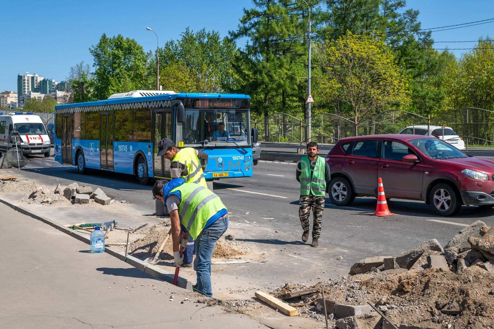 Moscow, Russia - May 9. 2018 - The Workers install curbs along the road in Zelenograd