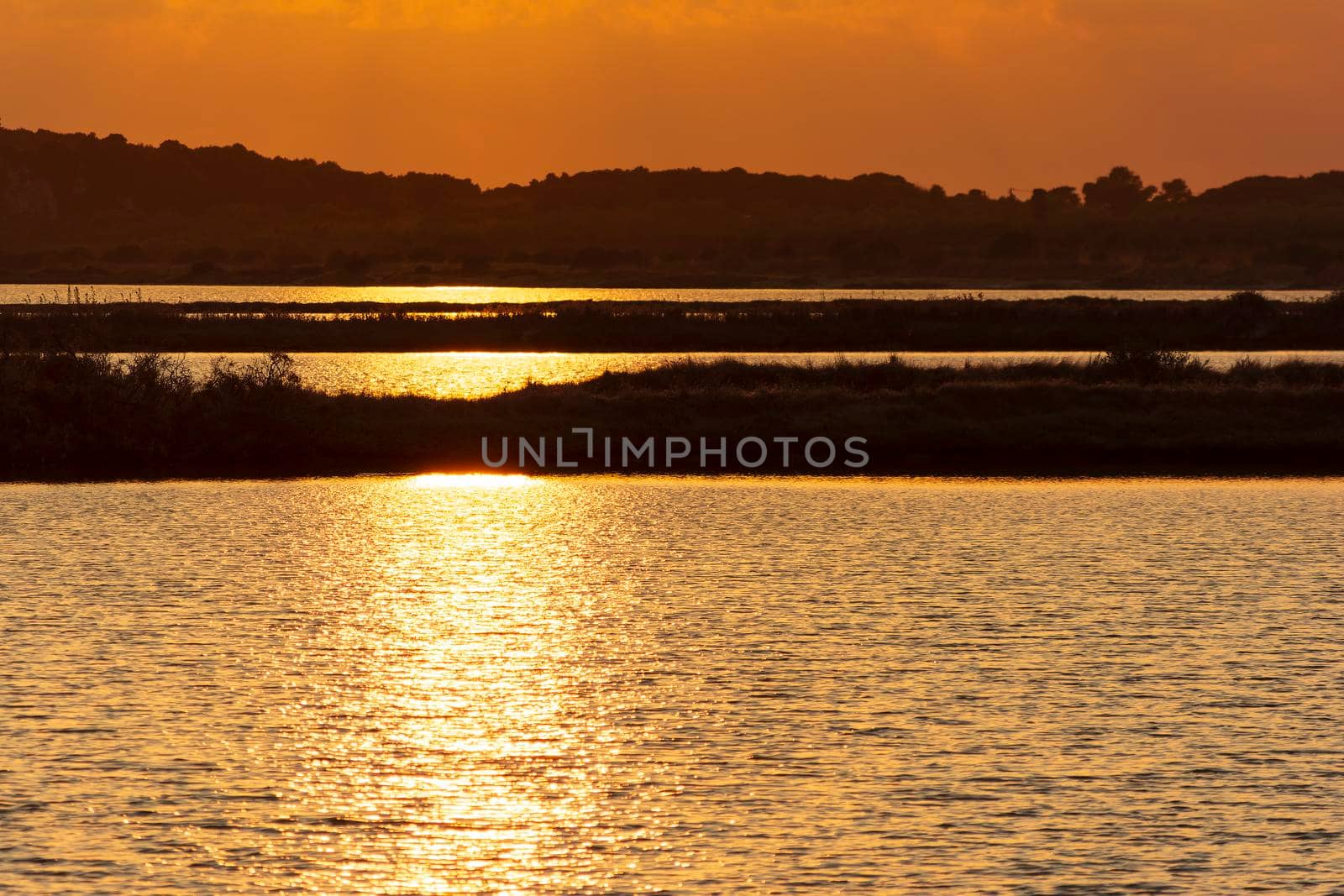 Sunset at the gialova lagoon. The gialova lagoon is one of the most important wetlands in Europe, as it constitutes the southernmost migratory station of migratory birds in the Balkans to and from Africa.