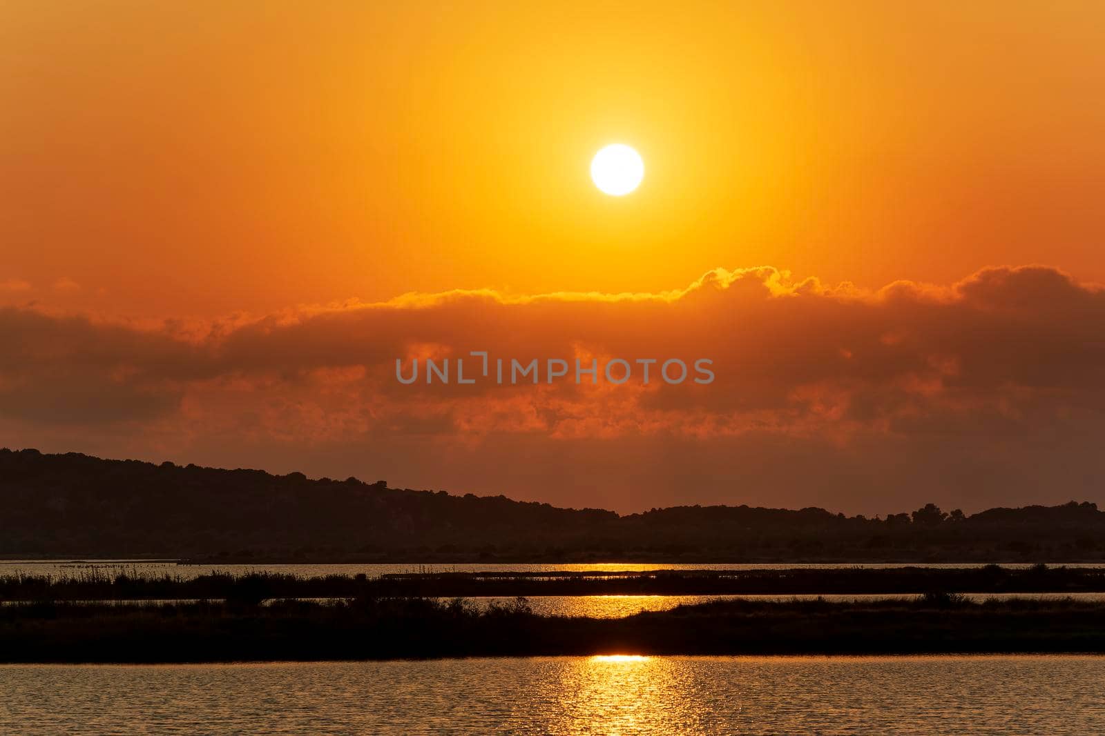 Sunset at the gialova lagoon. The gialova lagoon is one of the most important wetlands in Europe, as it constitutes the southernmost migratory station of migratory birds in the Balkans to and from Africa.