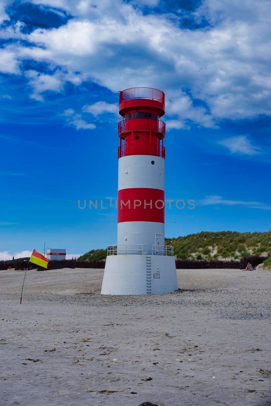 The red and white small Lighthouse on Island Dune - Heligoland - Germany with blue Sky