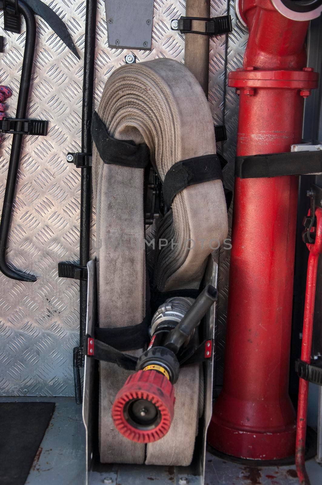 bunch of fire hoses on a firetruck. Rescue fire truck equipment. by inxti