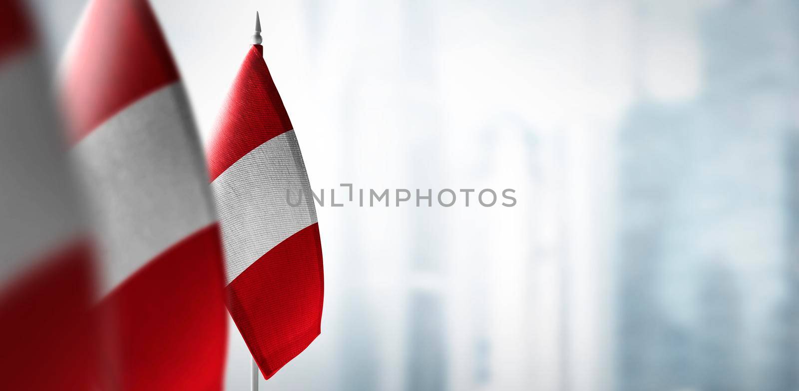 Small flags of Peru on a blurry background of the city by butenkow