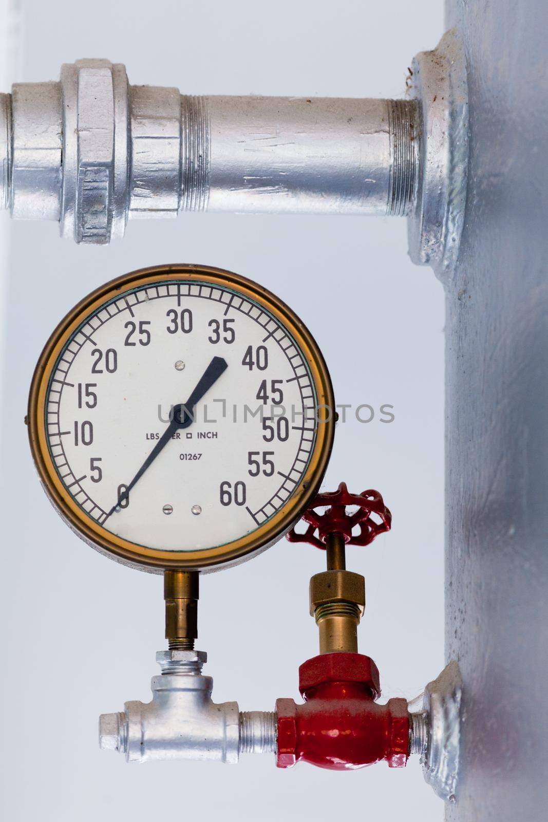 Vintage metal boiler tank with steampunk metal pressure gauge with scale in pounds lbs per square inch up to 60