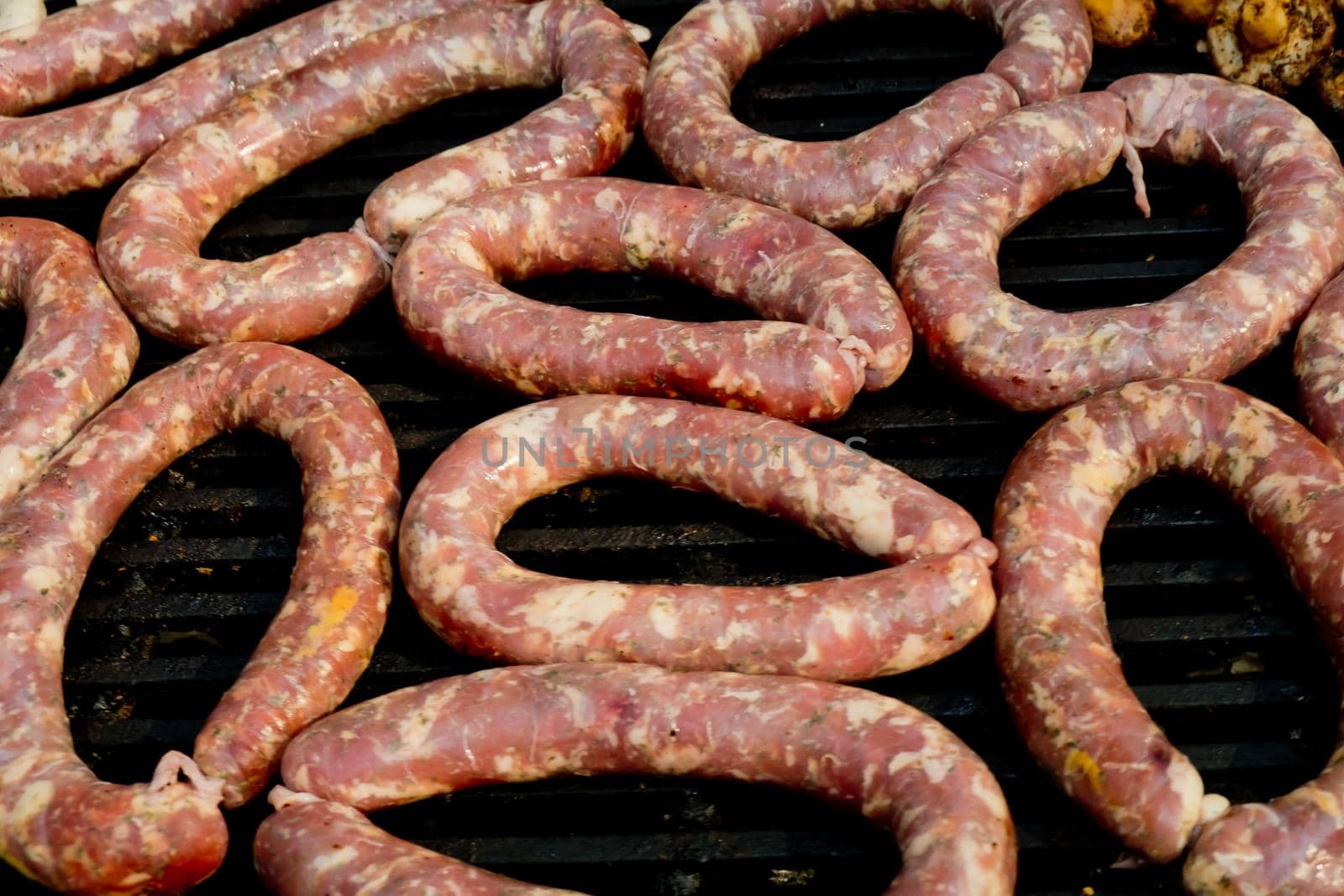 Grilled raw sausages. Street food festival. Selective focus. Close-up.