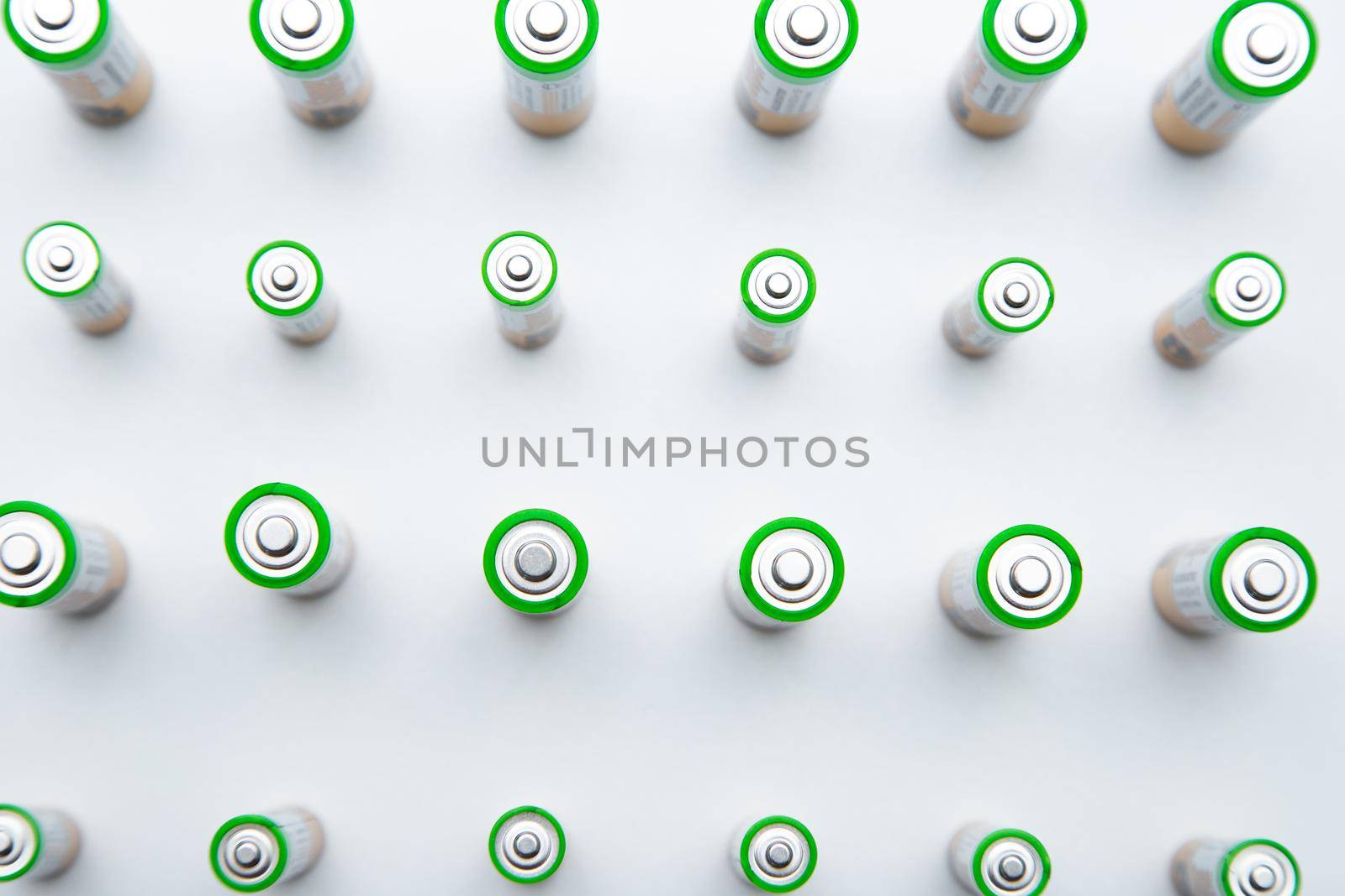 The batteries are arranged in a triangle in the upper corner of the photo on a white background. top view, flat lay, copy space, isolate. High quality photo