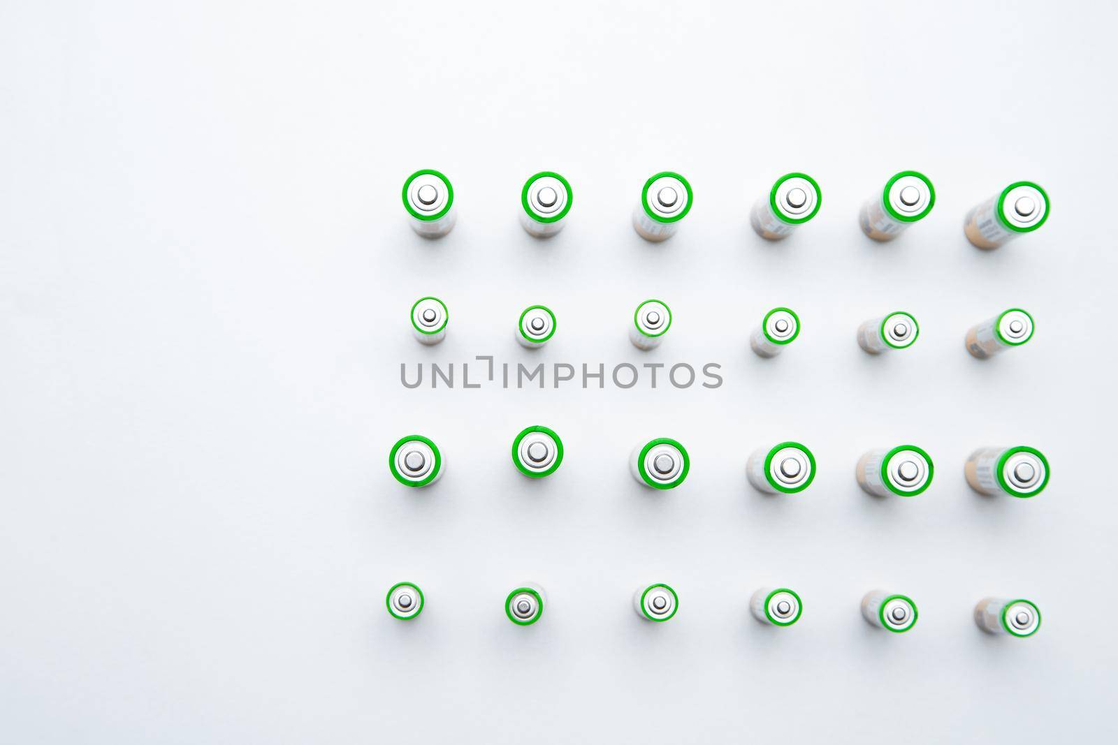 The batteries are arranged in a triangle in the upper corner of the photo on a white background. top view, flat lay, copy space, isolate. High quality photo