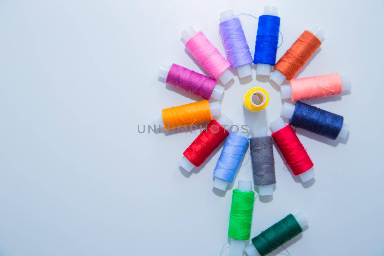 Skeins with threads are in the form of a creative flower on a white background. top view, flat lay, copy space, isolate. High quality photo