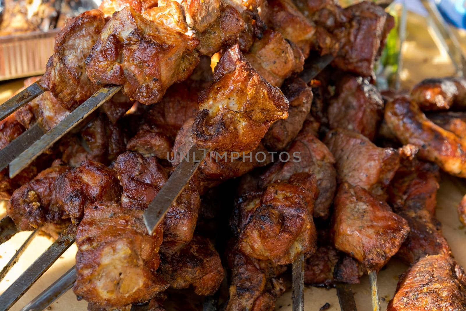 Fried kebab on skewers. Street food festival. Close-up. Selective focus. by leonik
