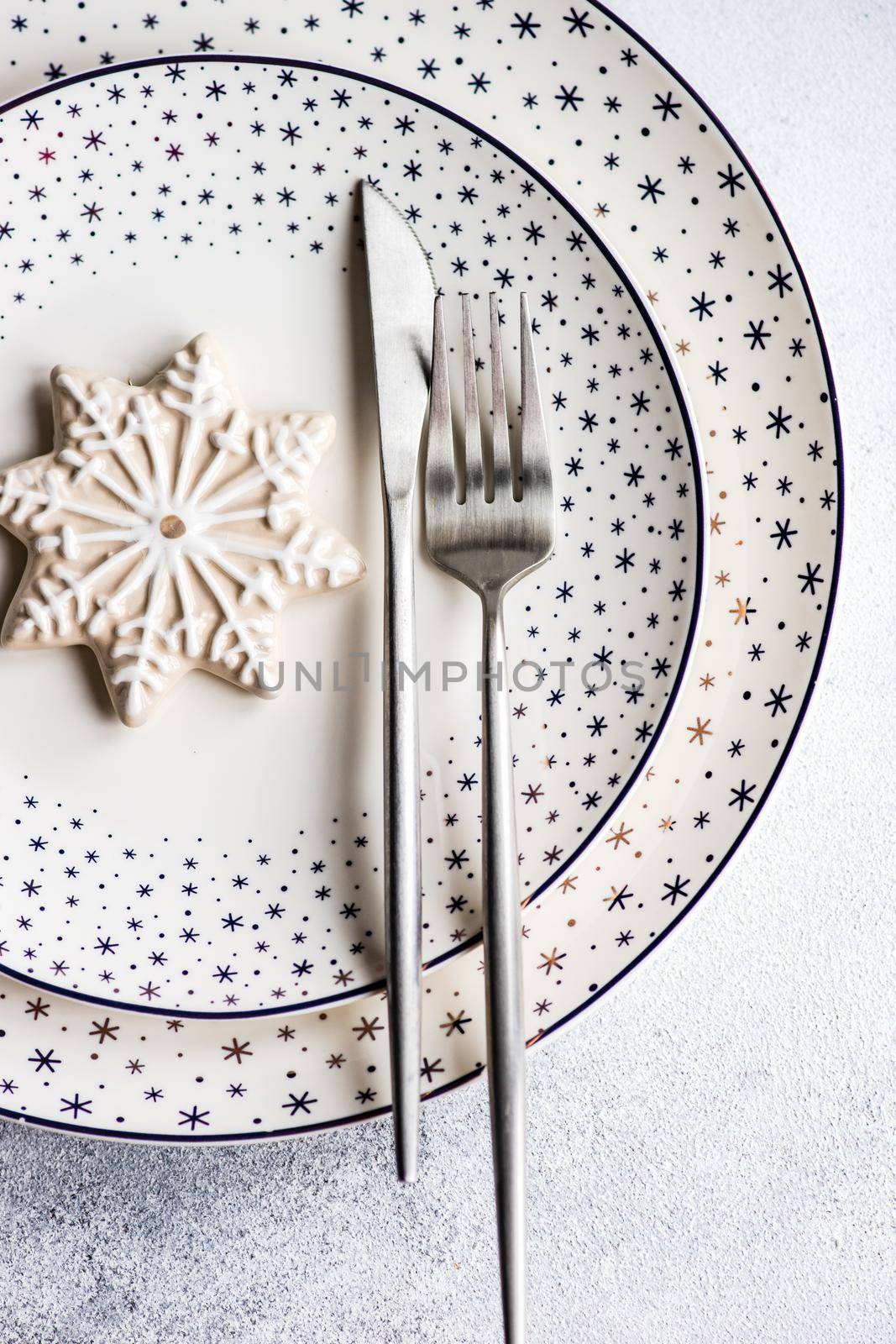 Festive place setting for holiday Christmas dinner on concrete table