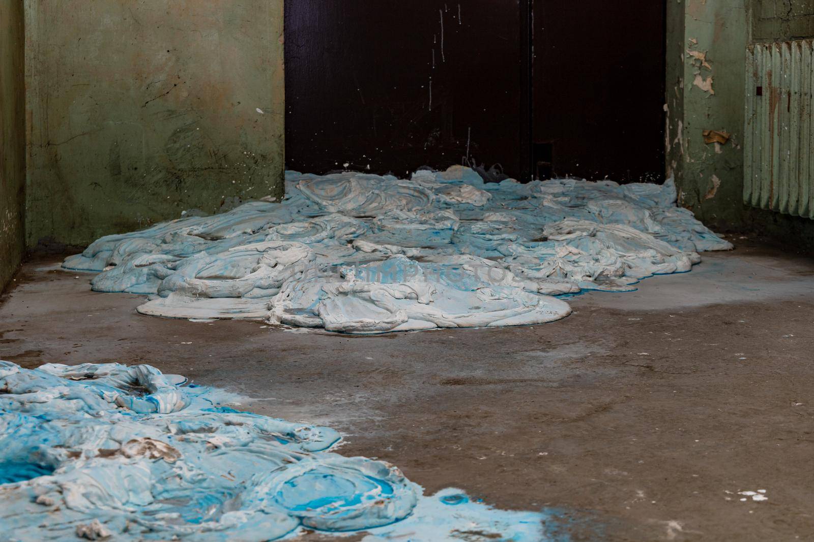 A lot of blue and white gypsum poured out on the floor