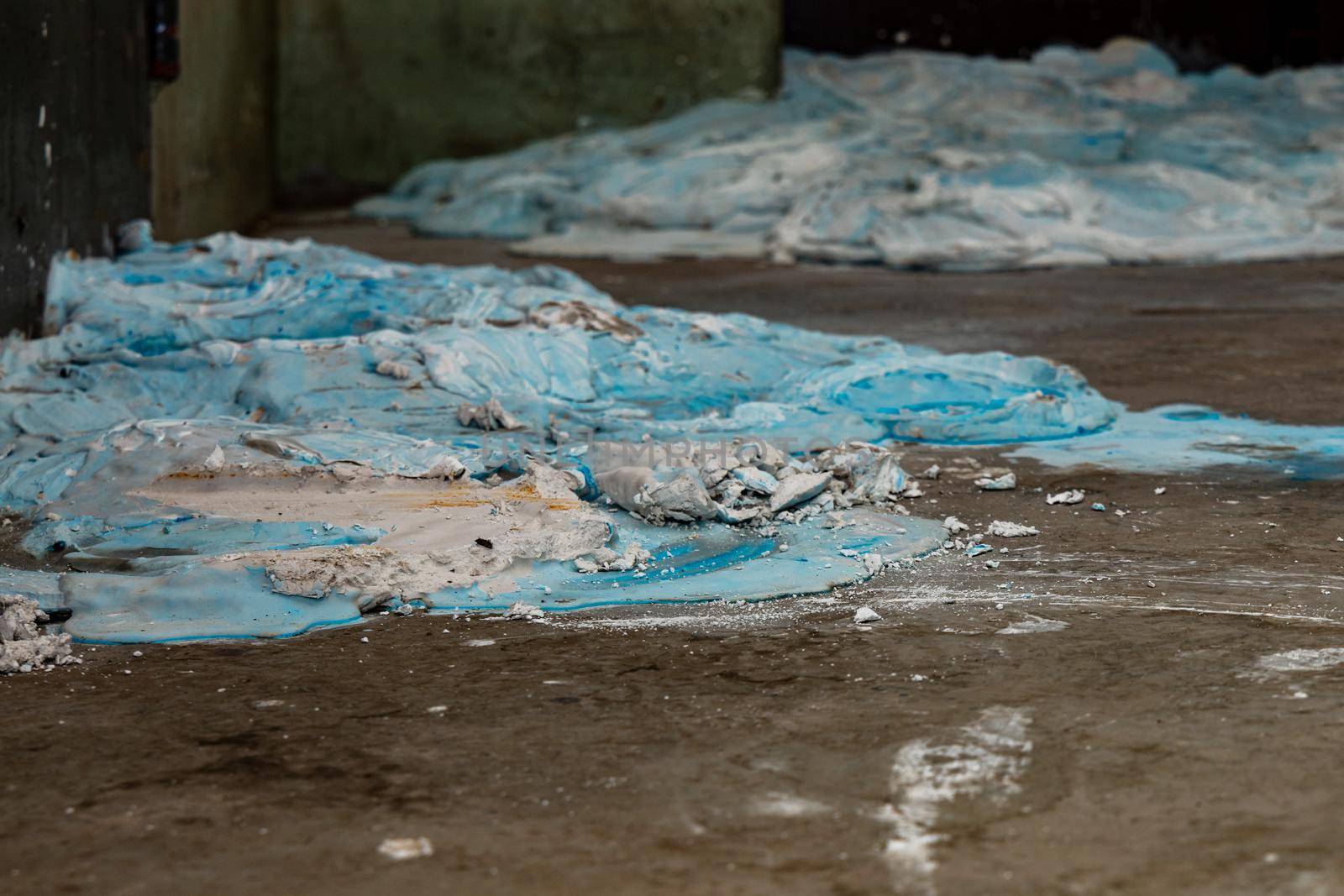 A lot of blue and white gypsum poured out on the floor