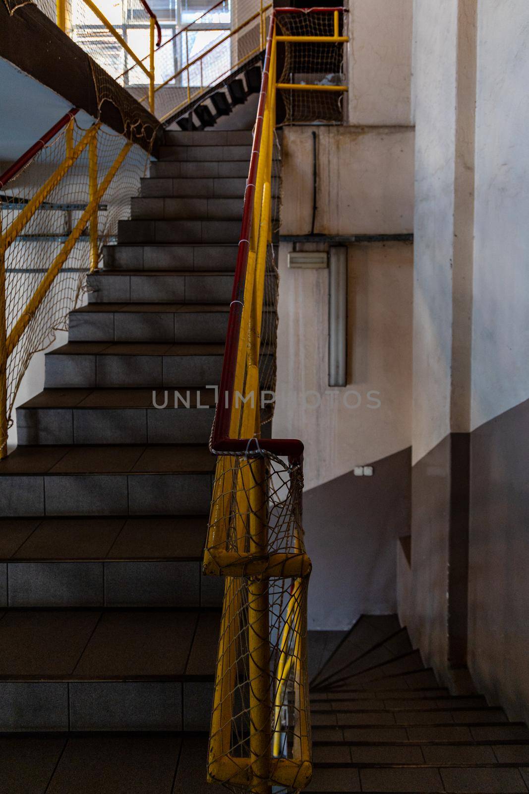 Stairs to up and down with yellow railings seen from mezzanine by Wierzchu