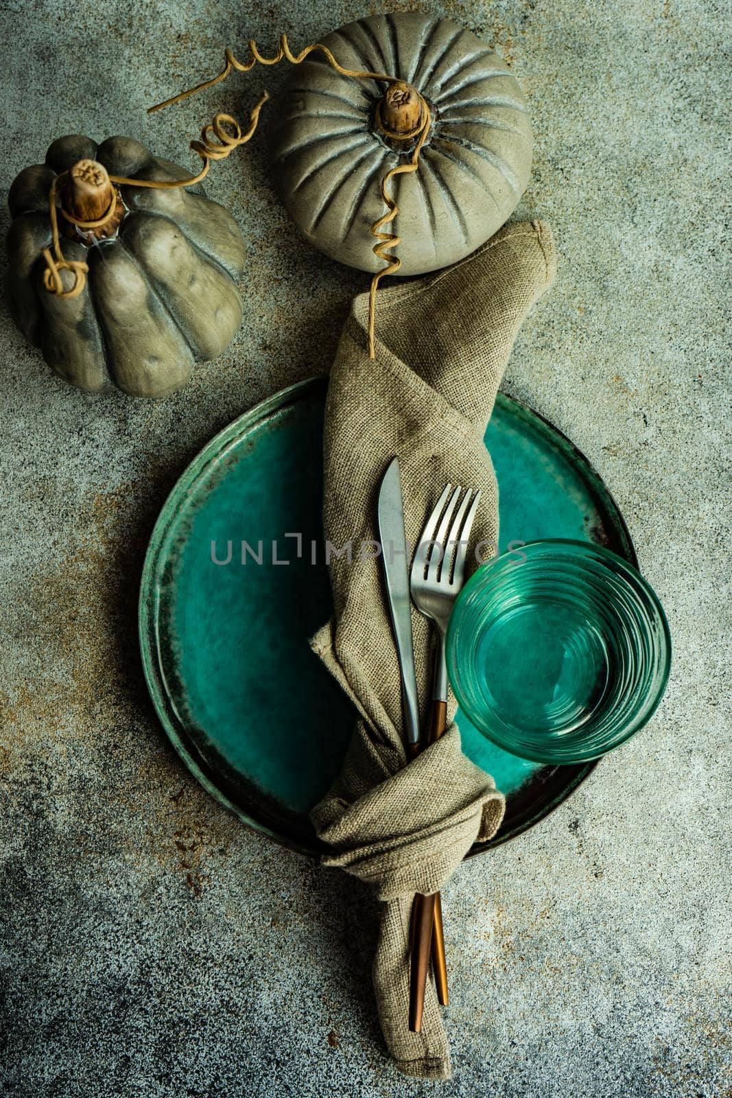 Autumnal table setting with leaves and  pumpkin on wooden table