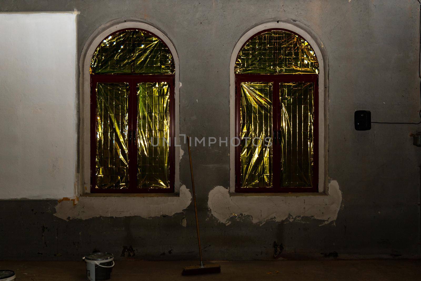 Two windows with yellow and green foil inside of big hall by Wierzchu