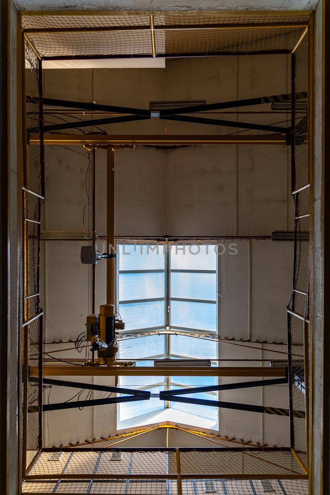 Looking up to hole in the floor and roof of old building by Wierzchu