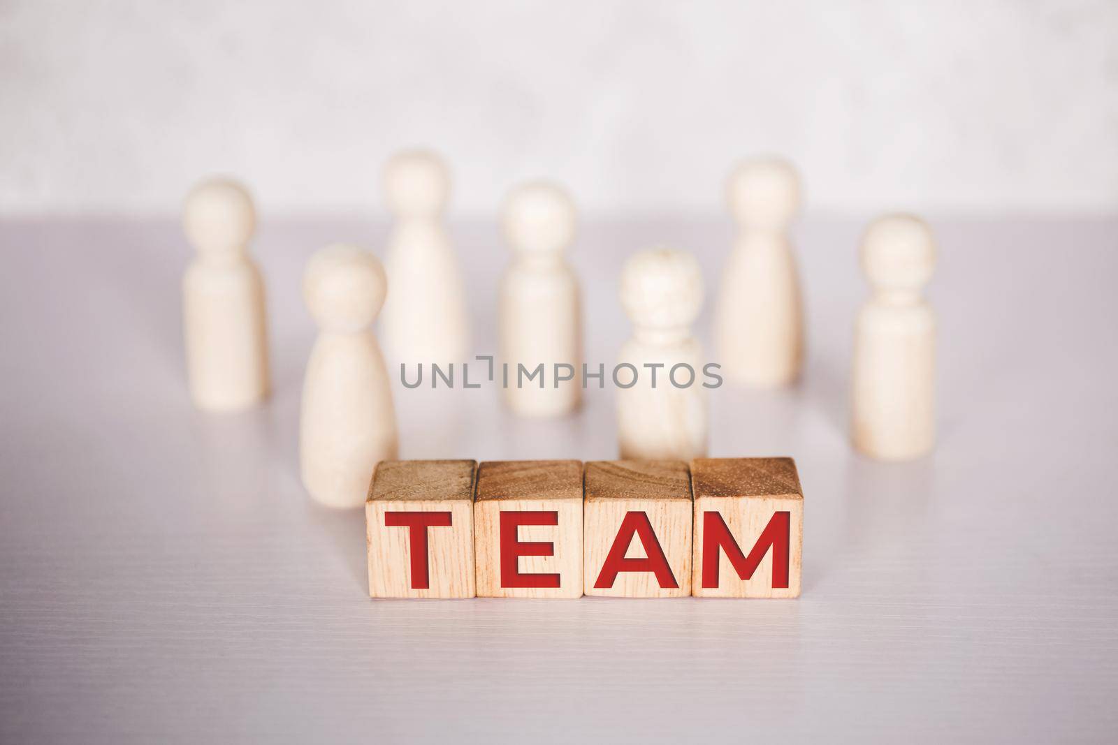 Word team on wooden block, relationship of collaboration and leadership for success, group of community and employee with corporate, teamwork for brainstorming together, no people, business concepts.