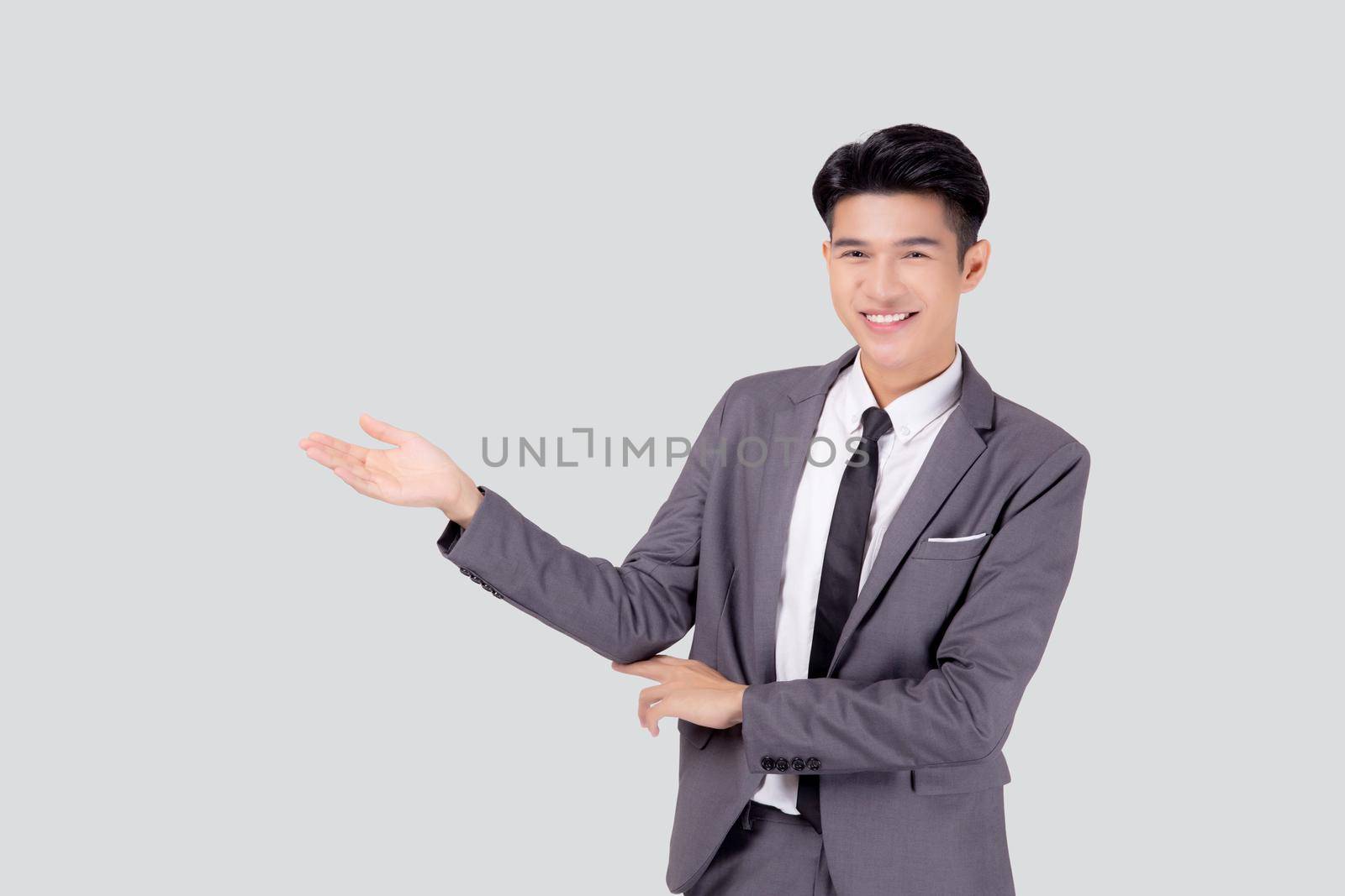 Portrait young asian business man in suit presenting isolated on white background, advertising and marketing, executive and manager, male confident showing success, expression and emotion. by nnudoo