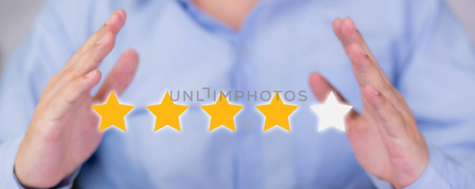 Customer business man holding star icon symbol for vote score review and feedback with quality and satisfaction, success of digital marketing with result excellent for ranking of service. by nnudoo