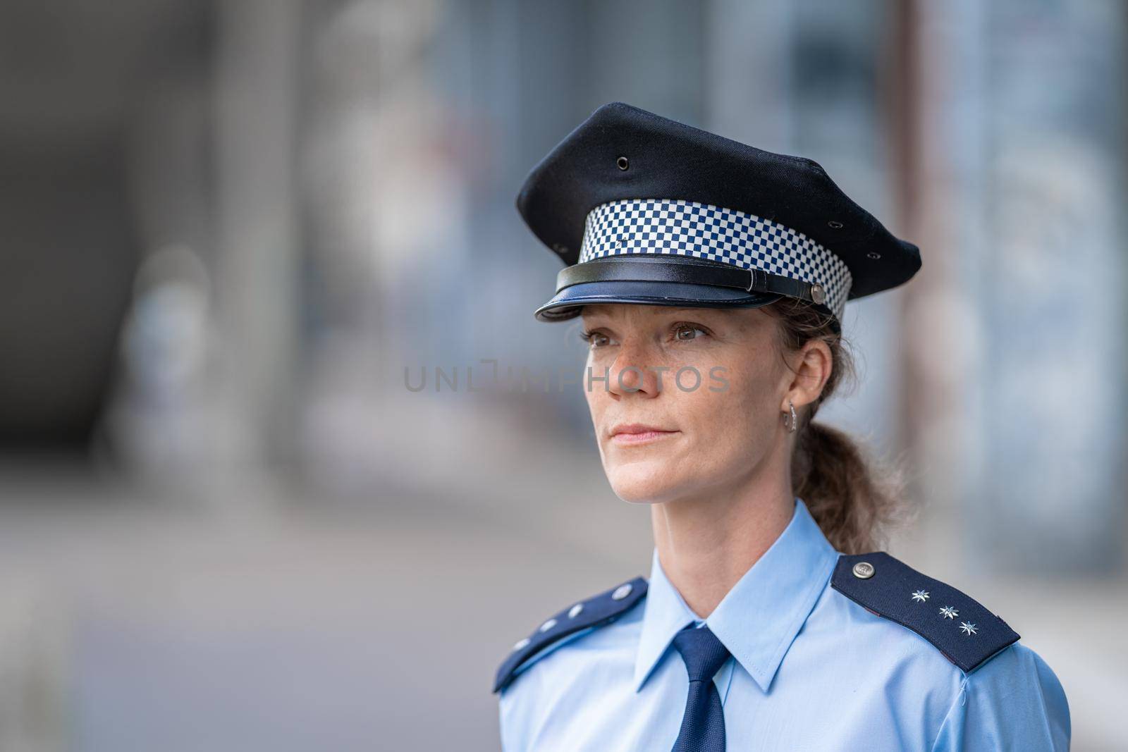 portrait of a young female policewoman in uniform.