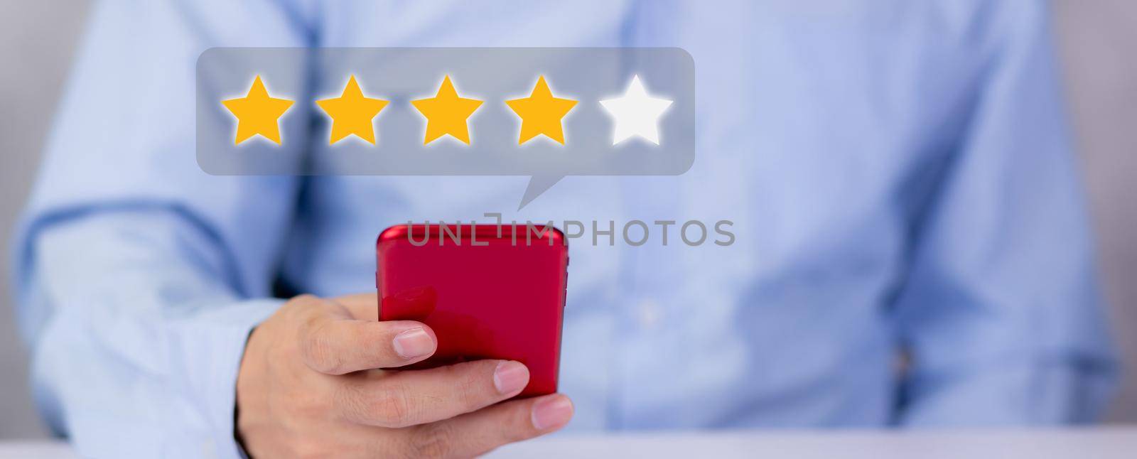 Customer holding phone and pressing star icon for vote score review and feedback with quality and satisfaction, success of digital marketing with result excellent for ranking of service. by nnudoo