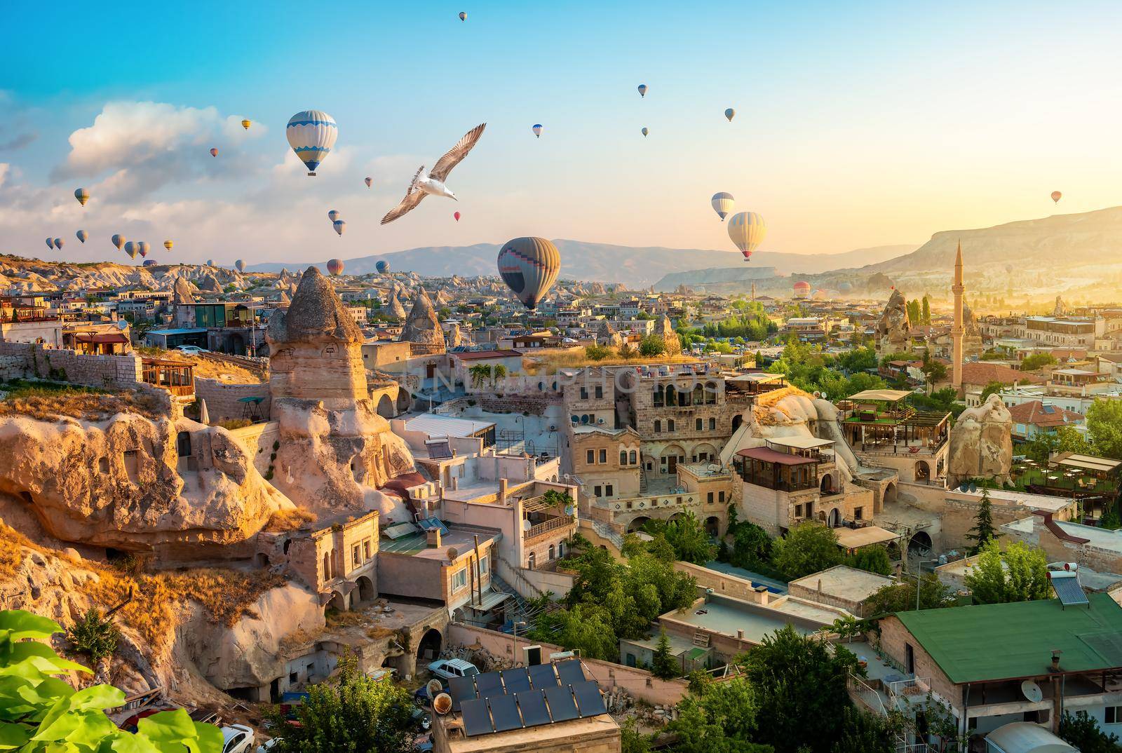 Hot air balloons at sunset in Goreme town, Cappadocia, Turkey