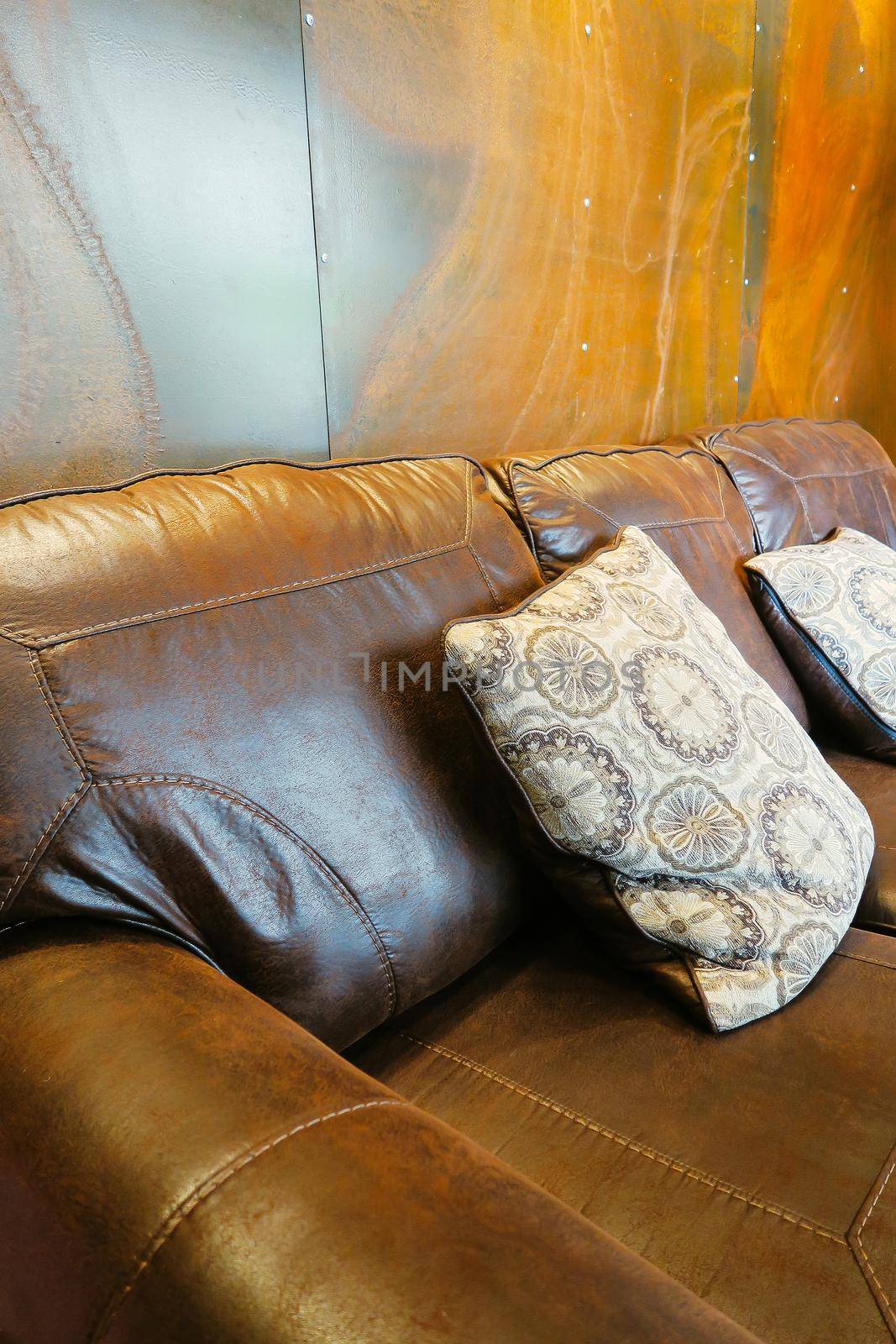Close up detail of white pillow on leather sofa