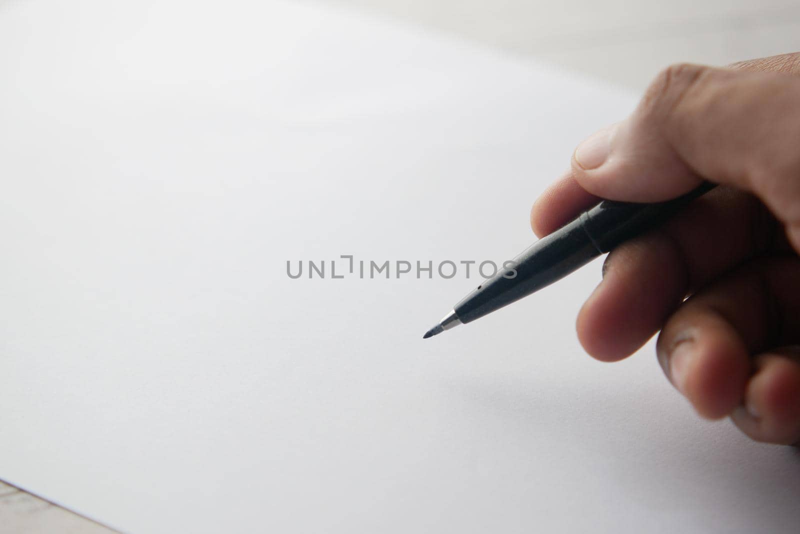 man's hand writing with pen on paper by towfiq007