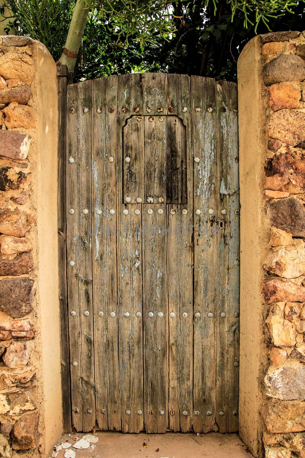 Old wooden gray door with iron details in Andalusa, Spain
