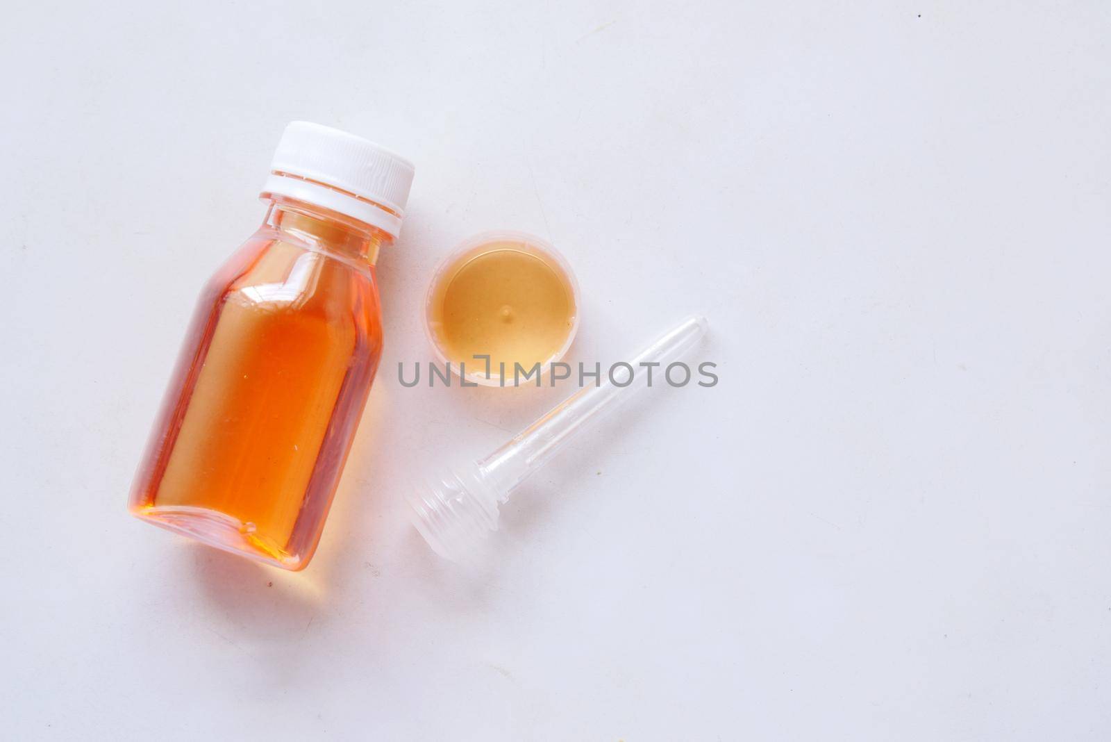 bottle with liquid medicine on white