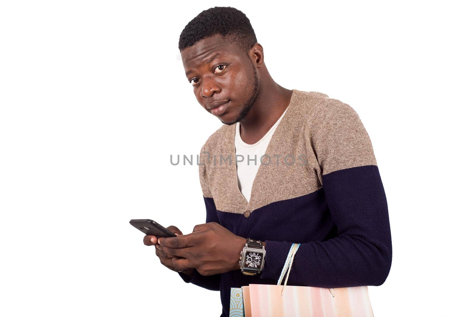 man in gray blue sweater with shopping bags talking on smart-phone isolated on white background