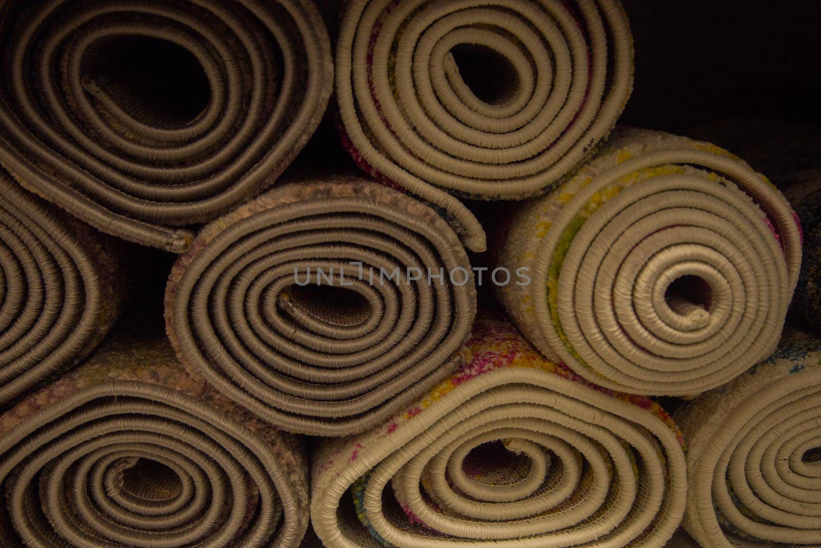 A lot of rolled-up carpets. High quality photo