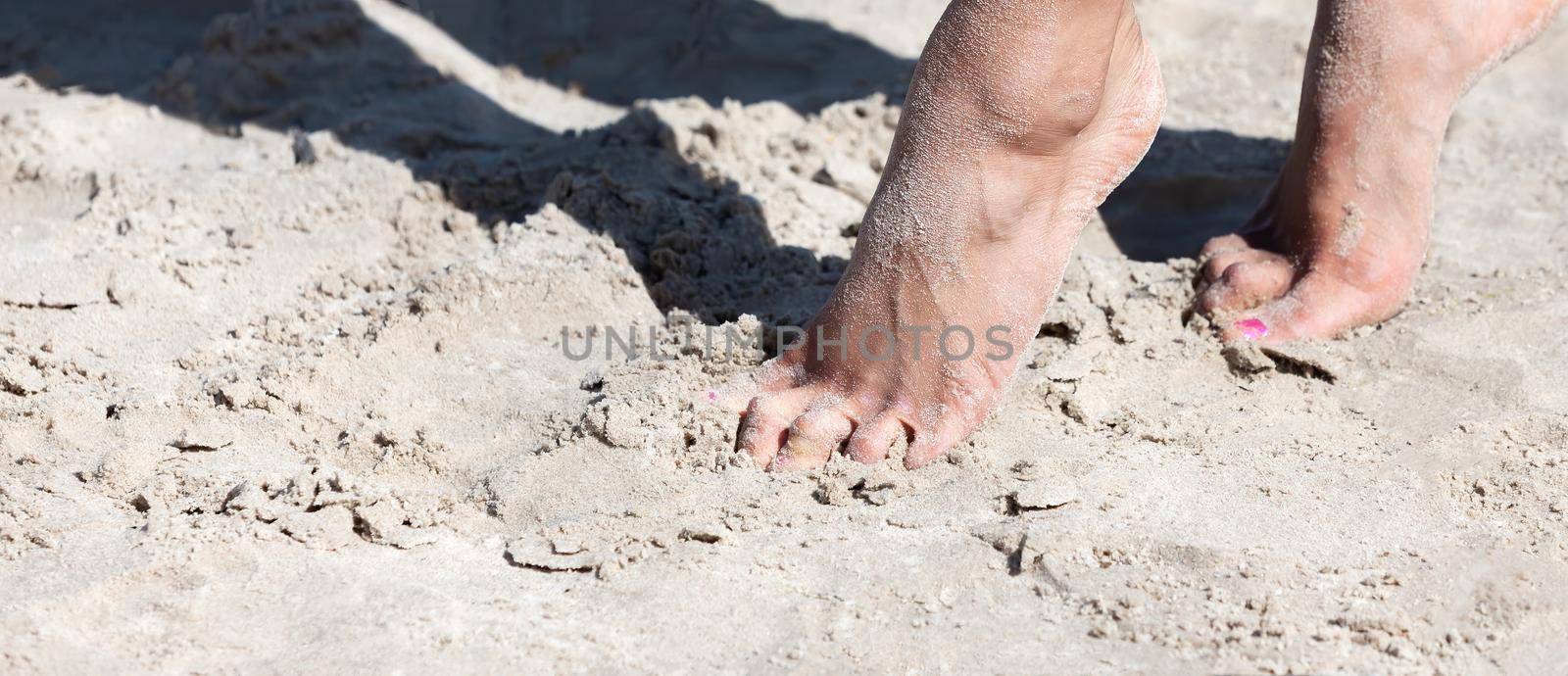 female feet on the seaside by palinchak