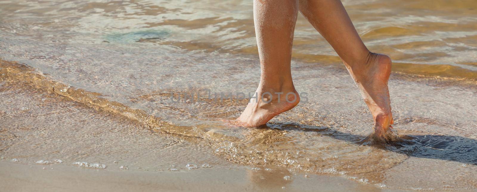 female feet on the seaside by palinchak
