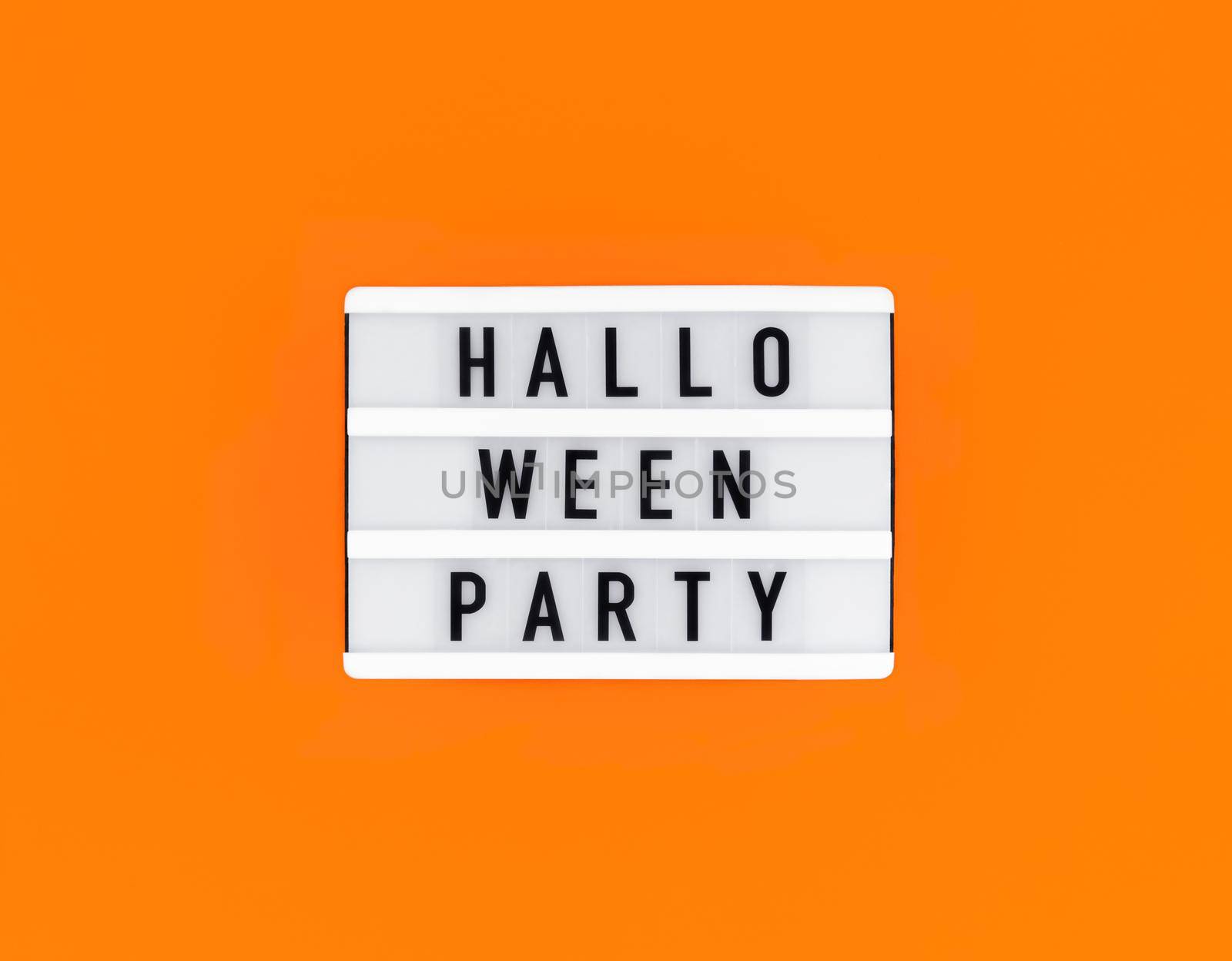 Light box with Halloween party text on an orange background.